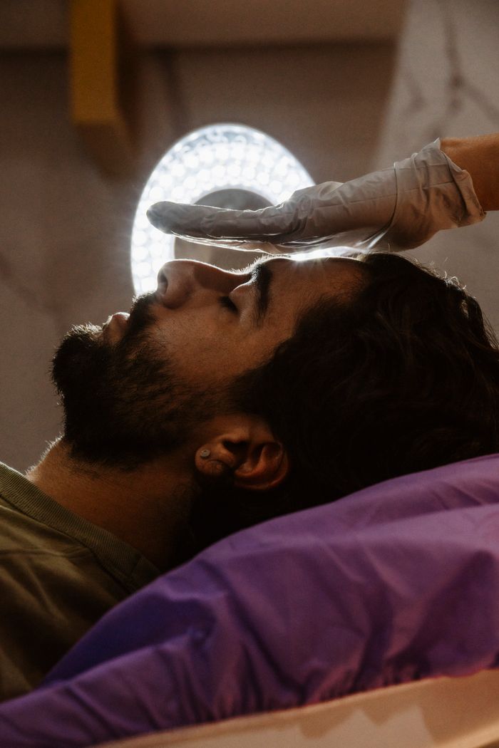 A person receives a soothing Reiki session, emphasizing relaxation and wellness.